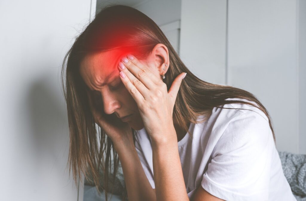 Woman with headache rubbing her temples.