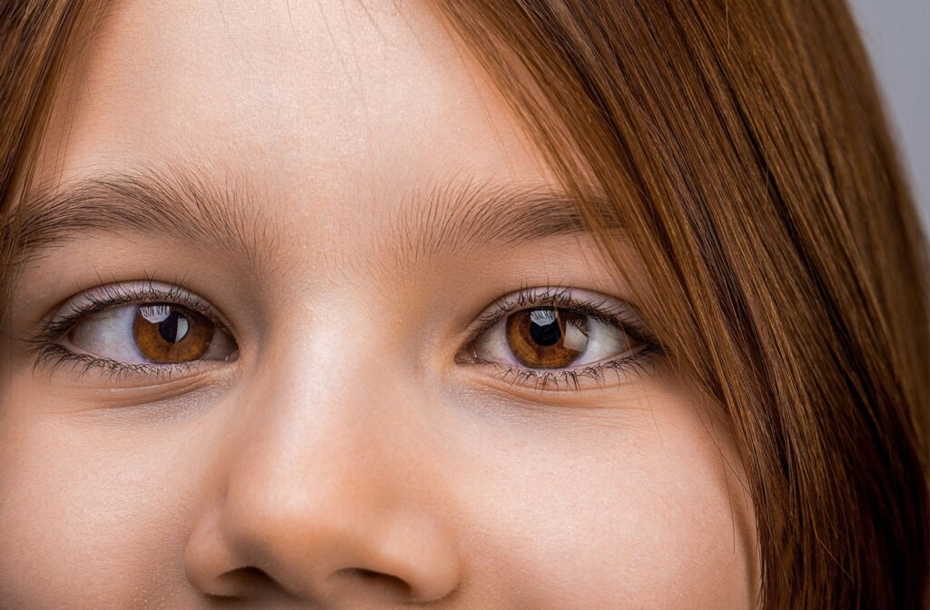 A child uses a string during their vision therapy session to work on proper eye alignment.